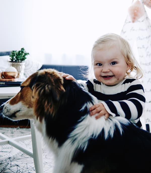 A portrait of Kalea and pet dog.