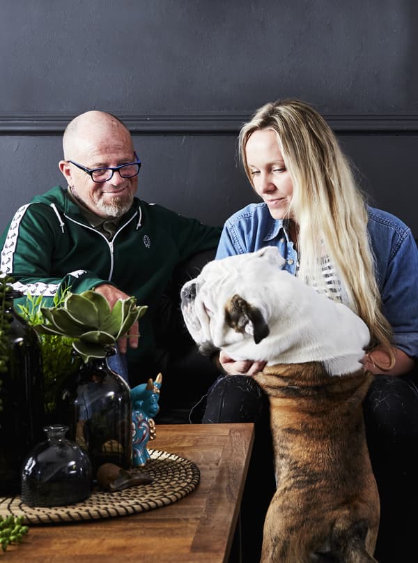 A portrait of Pati, Colin and their dog.