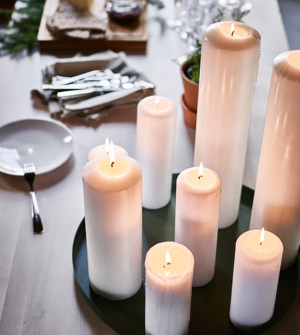 A prepped buffet table with a candle centrepiece.