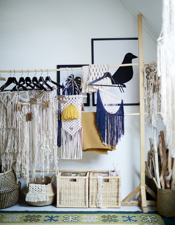 A rail-hanger storage system filled with textiles.