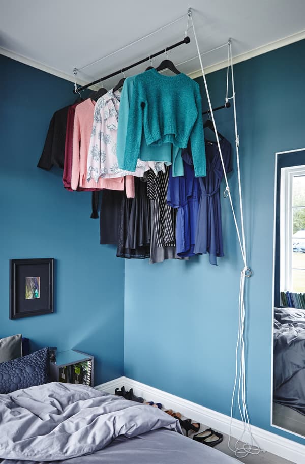 A raisable wardrobe in a bedroom. It be rolled up when not in use and down when you need to get dressed and undressed.