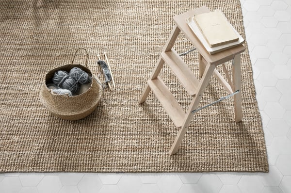 A rattan IKEA rug with a step stool