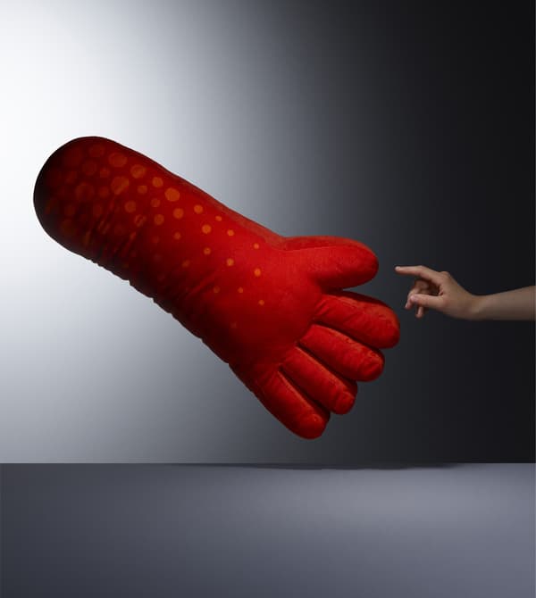 A red hand-shaped cushion.