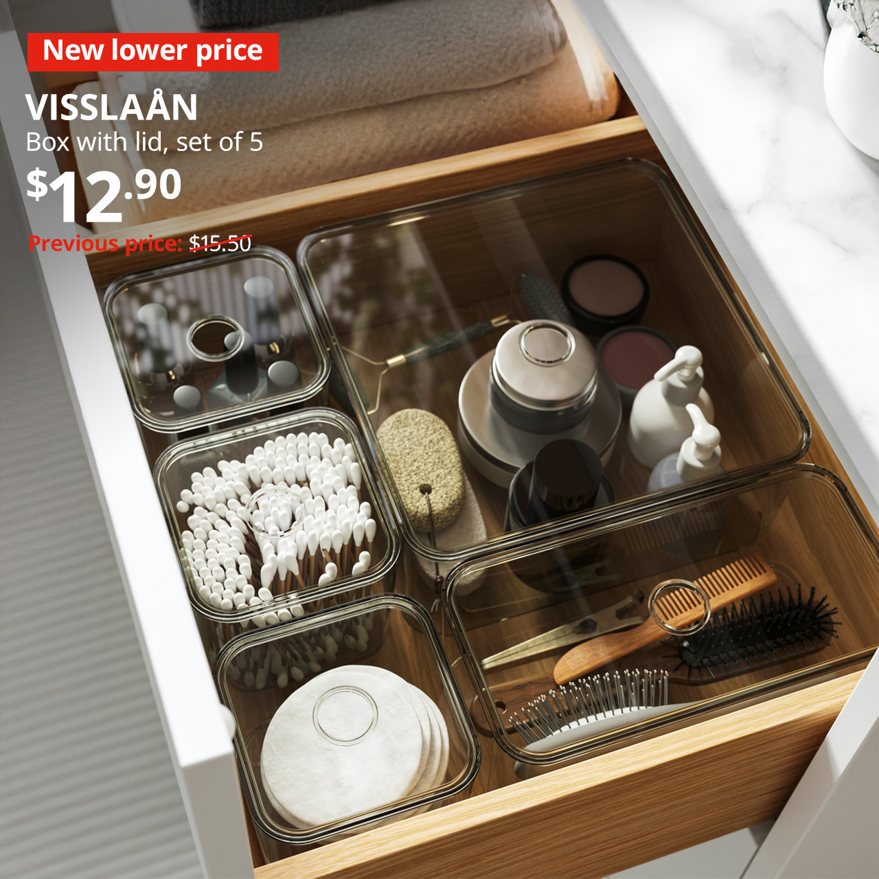 A red tag with white text that reads "New lower price". A grey VISSLAÅN box with compartments is used to organise the bathroom cabinet drawer. Black text on image reads "VISSLAÅN, Box with lid, set of 5. Price: $12.90" Previous price with red slash: $15.50