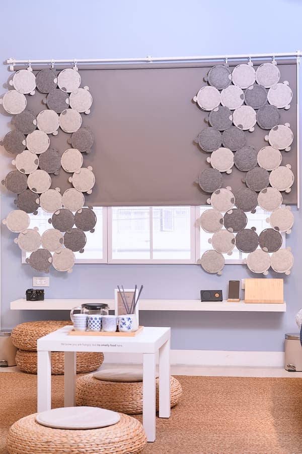 A relaxing corner featuring cushions and a small side table placed on the floor.