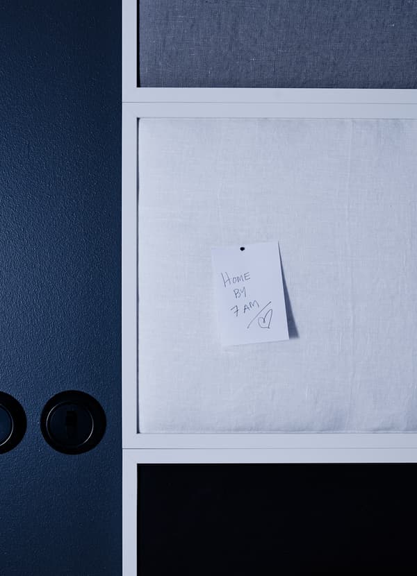 A remote control storage pocket has been remodelled to store a charging mobile phone while hanging from the side of a bed.