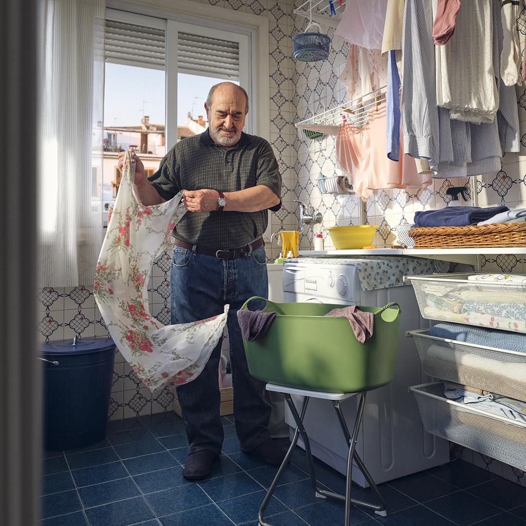 A retired man doing laundry in a laundry room