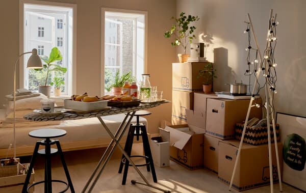 A room mid-moving in with stacked moving boxes.