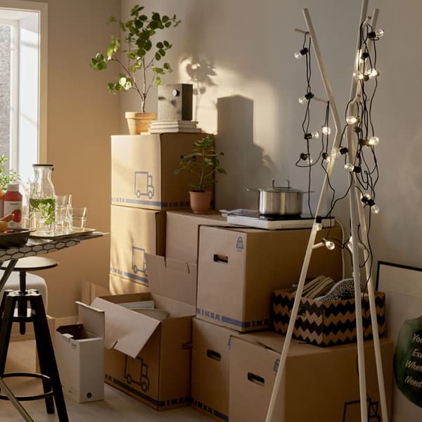 A room with multiple moving boxes everywhere, partially being unpacked.