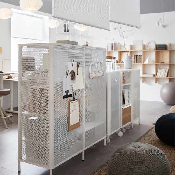 A row of IKEA BEKANT white mesh shelving units, with magnetic sides for clips and hooks.