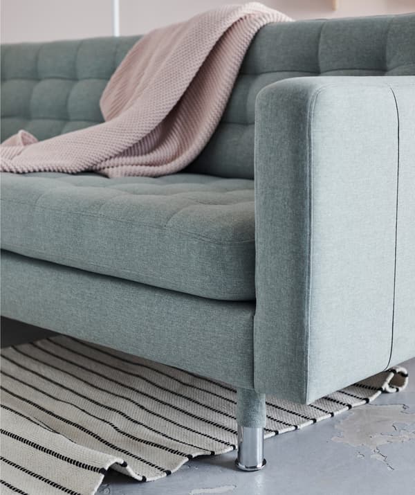 A rug and a throw create a variety of finishes, completing your cosy sofa corner.