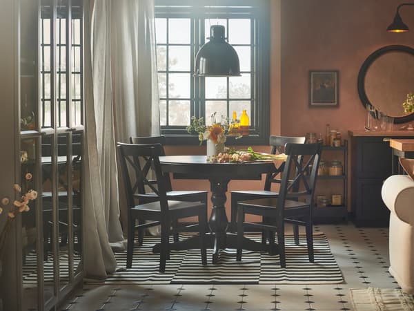 A rustic dining space with pink-coloured walls, an INGATORP extendable table and four INGOLF chairs.