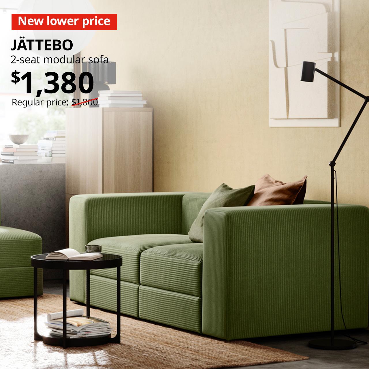 A samsala dark yellow-green JÄTTEBO 2-seat modular sofa in a living room setting with New lower price tag. Price: $1,380. Regular price with red slash: $1,800.