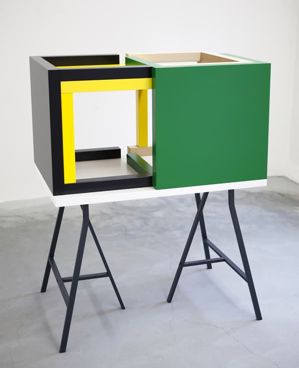 A sculpture made from a collection of IKEA tables.