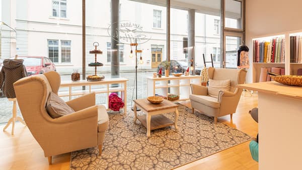 A seating area with two wing chairs and a coffee table in a shop.