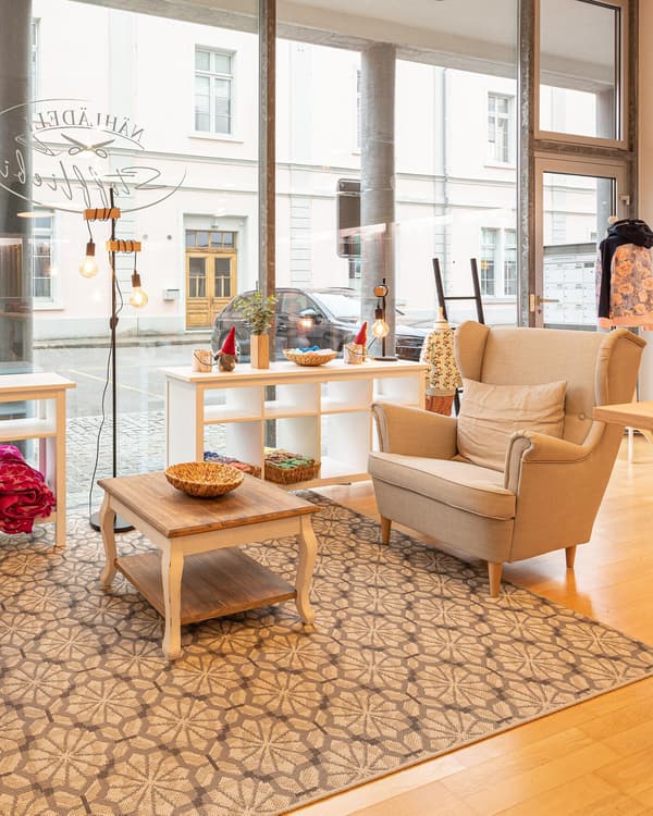 A seating area with wing chairs in a shop.