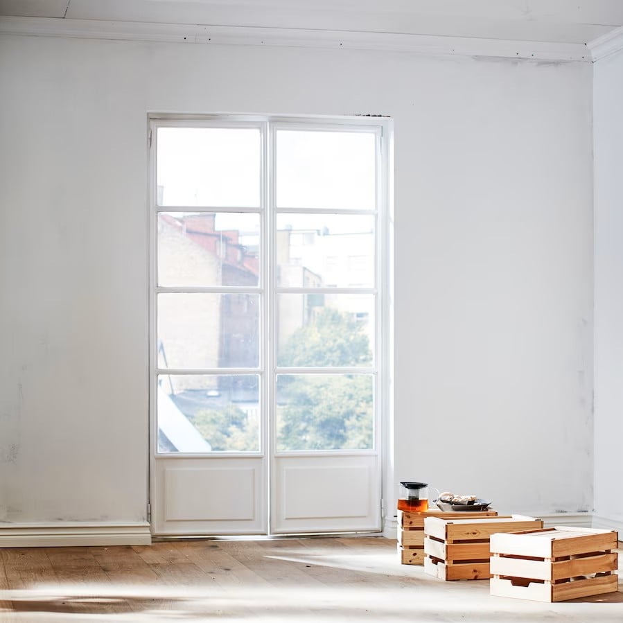 a-section-of-an-empty-room-with-a-white-unpainted-wall