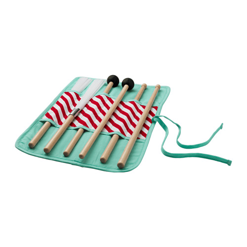 A set of drumsticks in a light green holder against a white background.