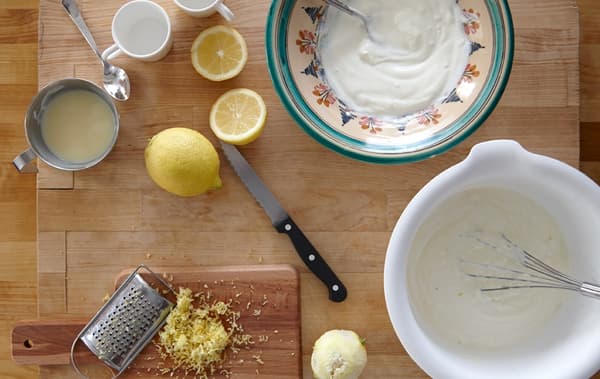 A set of ingredients for lemon mousse, including lemon rind, juice, yogurt and condensed milk