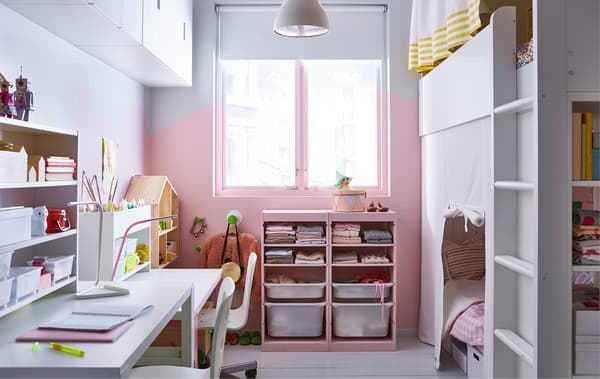 A shared kids’ room with a loft bed, storage and two desks.
