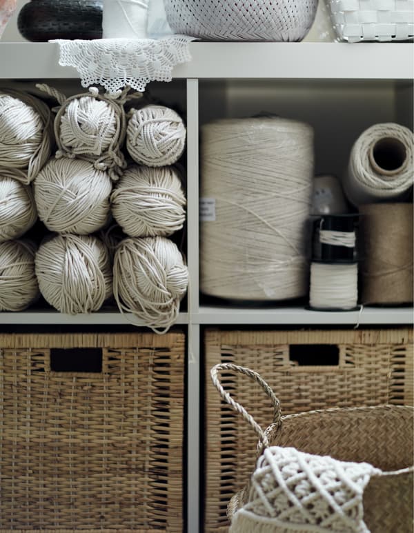 A shelving unit and drawers filled with textiles.
