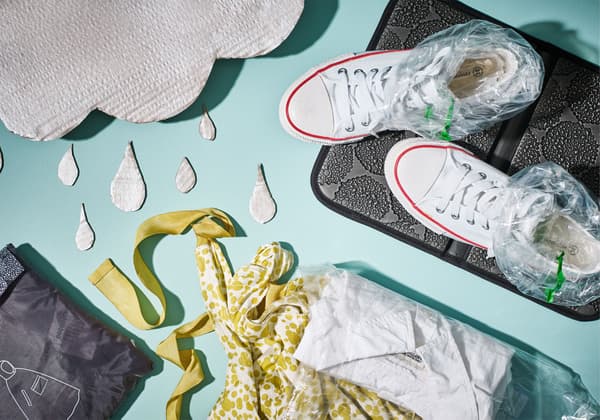A shot from aboce of a pair of sneakers with plastic bags inside, a seat pad, and a change of clothes neatly folded.