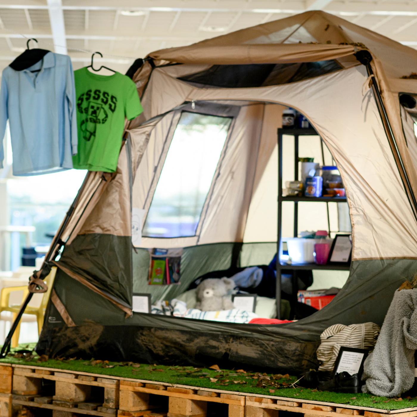 A showcase of a living situation for a mother and two children living in a tent