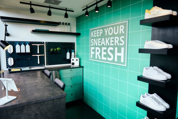 A side view of inside a shoe shop with green walls