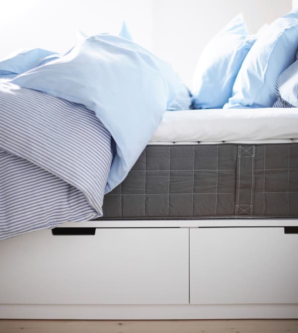 A sideview of a bed shows the built-in under-bed drawers for storage.