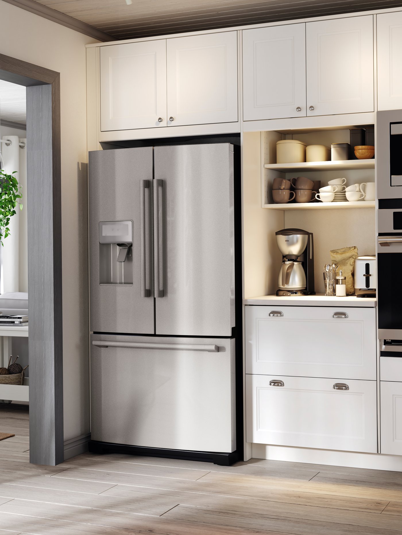 A silver French door refrigerator tucked between white kitchen cabinets. A coffeemaker and toaster are on the worktop.