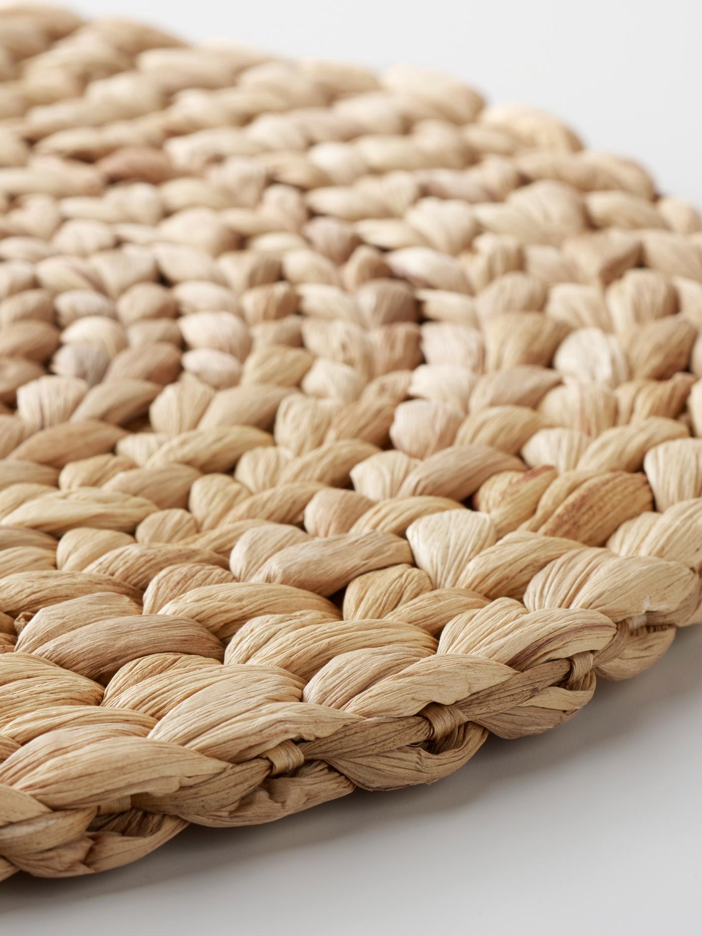 A single SOARÉ place mat laying on a white surface.