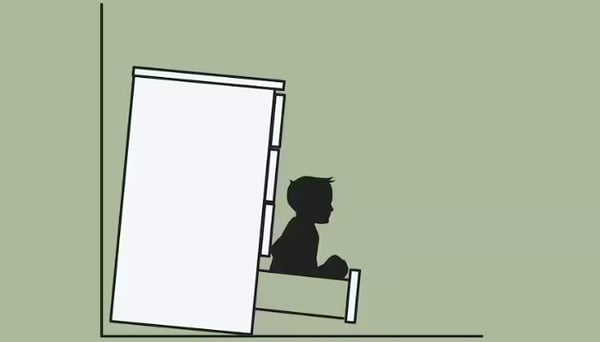 A sketch of a chest of drawers, not secured to the wall, tipping over on a small child who is sitting in a drawer.