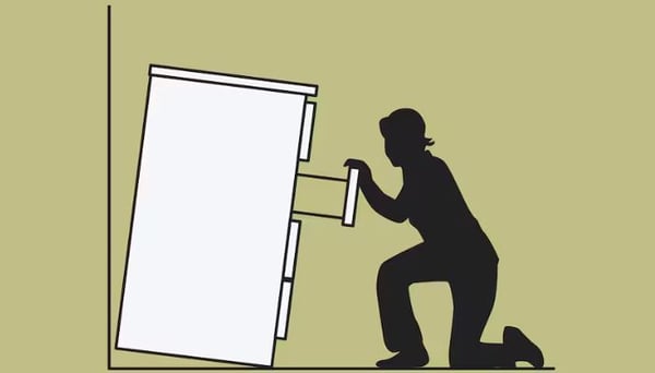 A sketch of a chest of drawers, not secured to the wall, tipping over on a kneeling woman who is pulling on a drawer.