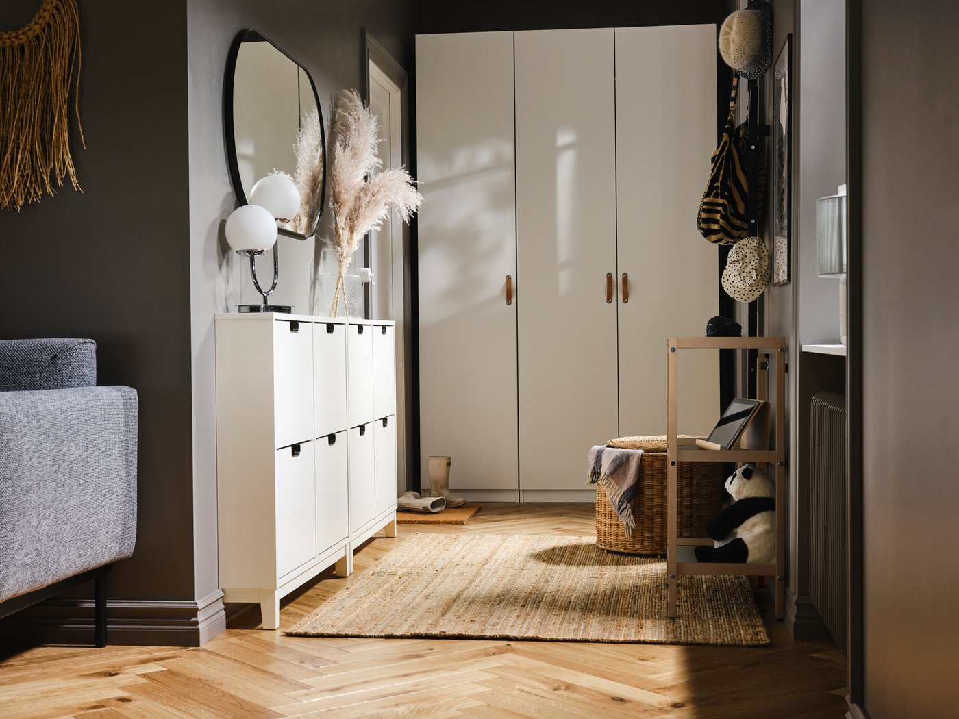 A small entryway with a PAX/FORSAND wardrobe at one end and two white STÄLL shoe cabinets with 4 compartments on one side.