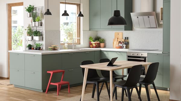A small, modern kitchen with white walls and high-gloss grey-turquoise doors. 