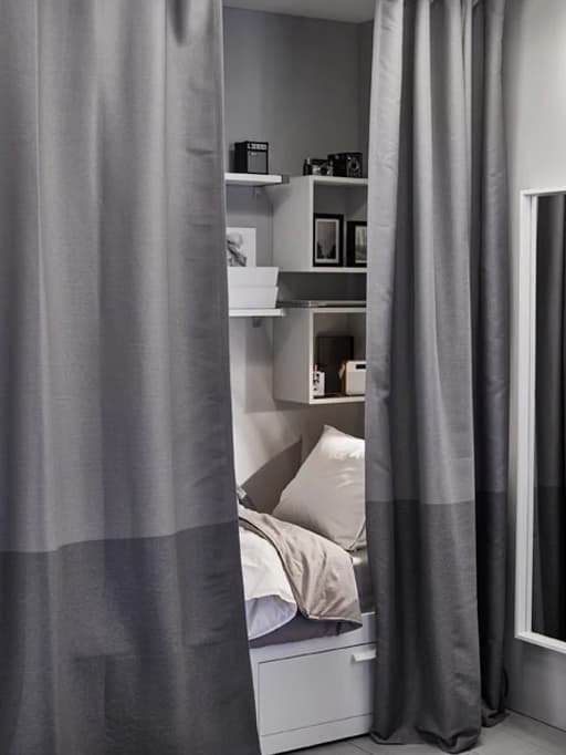 A small sleeping space gets extra privacy with curtains that work as a room divider. 