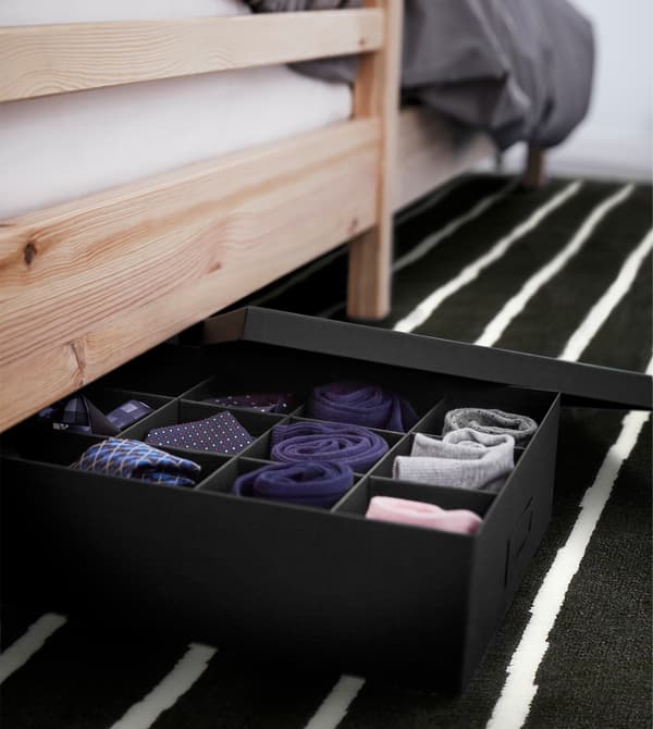 A small space organisation tip for your dorm room is to use all your space. Under your bed, put a TJENA box with compartments for socks and small accessories. IKEA has a wide selection of storage boxes in different colours and sizes to sort your stuff.