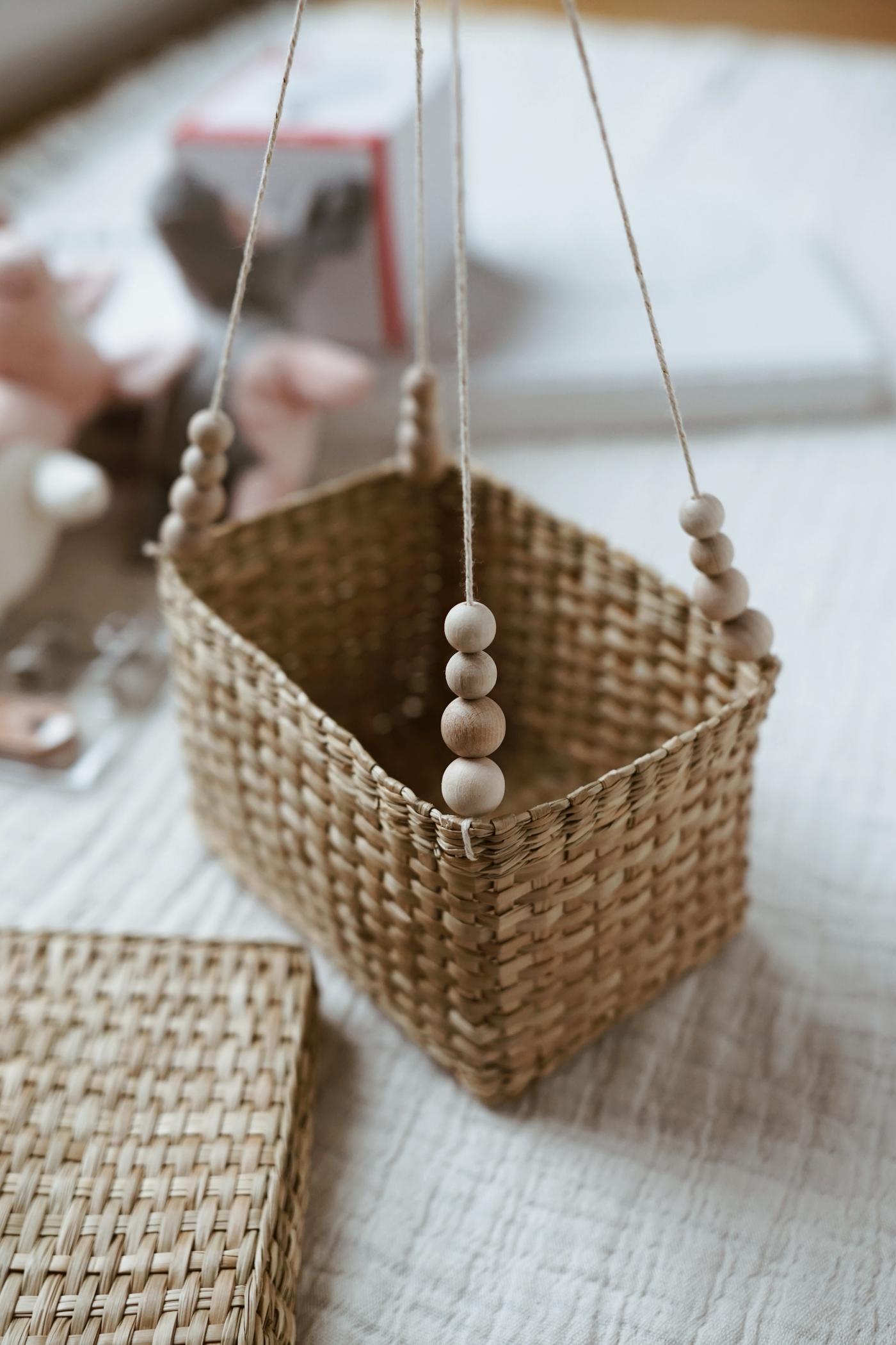 A small woven basket with four strings of beads attached