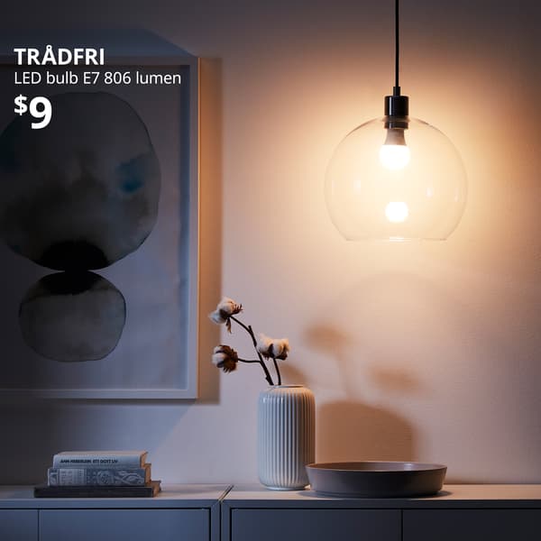 A smart wireess dimmable/warm white globe TRÅDFRI LED bulb E27 806 lumen. White text on top left of the image reads: TRÅDFRI, LED bulb E27 806 lumen. Price: $9