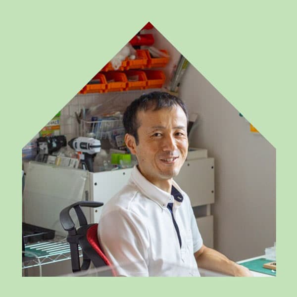 A smiling man looking towards the camera.