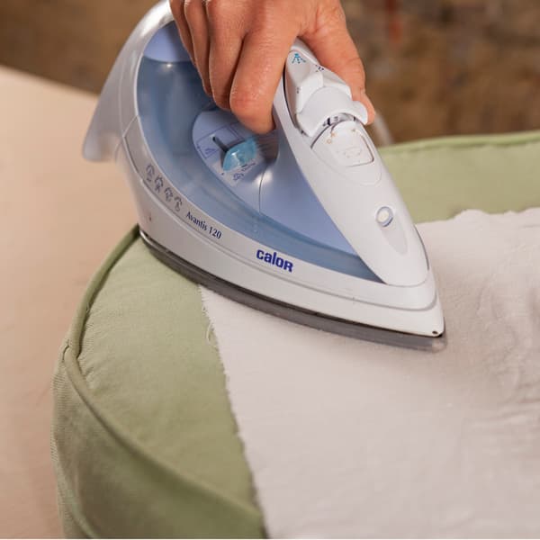 A smoothing iron is used to fix the motif.