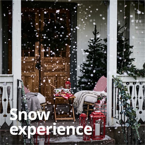 A snowy shot of a house front porch.