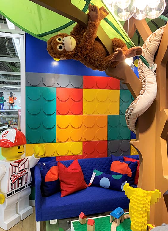A soft toy monkey hanging in a kids playroom