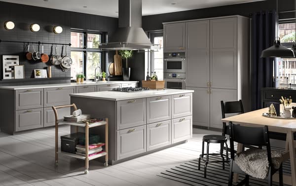 A spacious grey and white kitchen with a cooking island as the heart of the space.