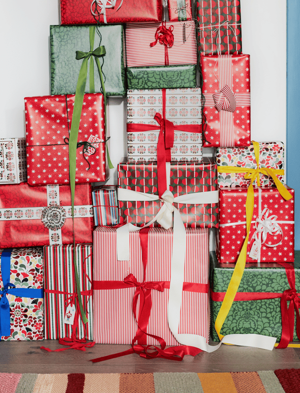 A stack of presents wrapped in colourful paper.