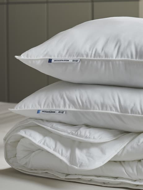 a stack of white duvets and pillows