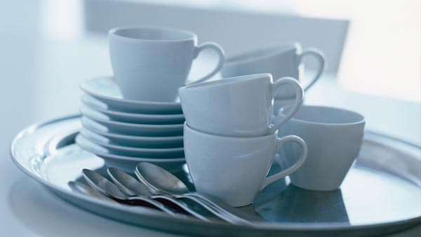 a stacked full service of dinnerware on a tray