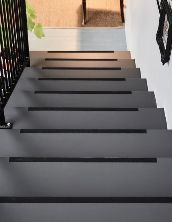 A staircase with anti-slip strips on every stair.