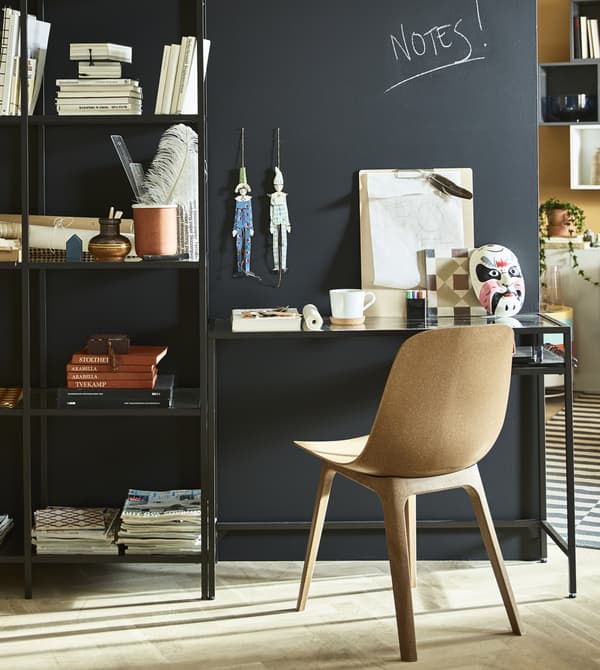 A stand-alone wall with a workspace sits in teh middle of a living room.