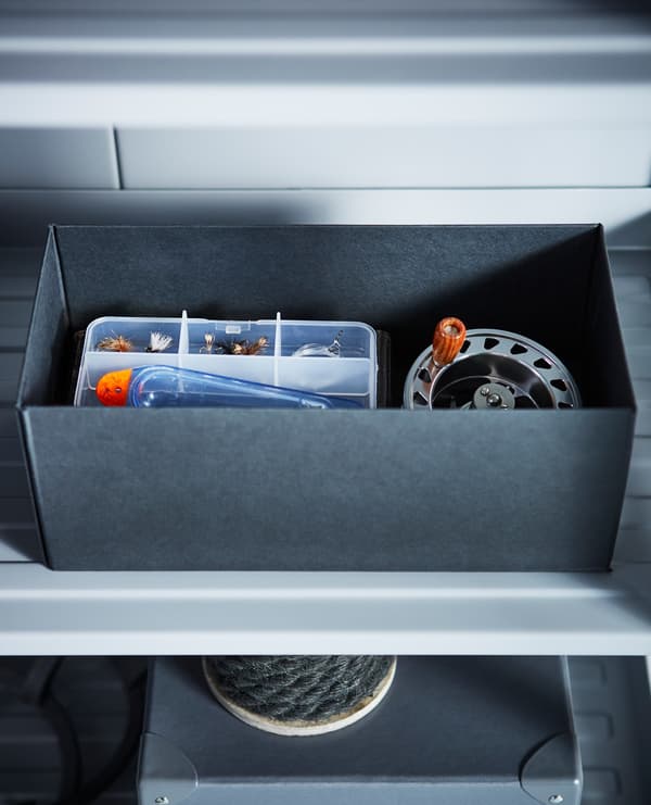 A storage box with fishing equipment inside.
